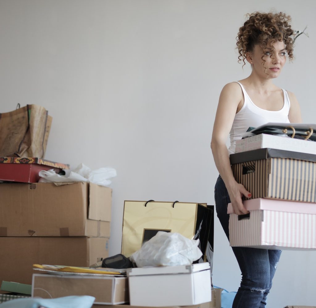 A woman organizing and moving boxes.