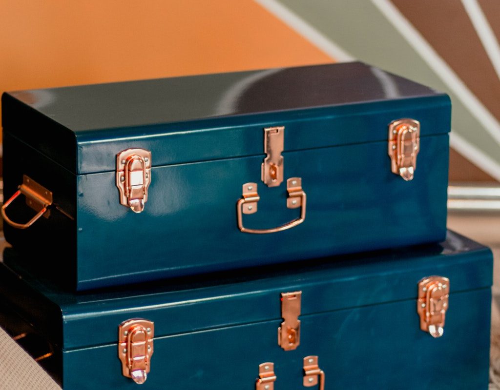 Vintage blue suitcases stacked up.