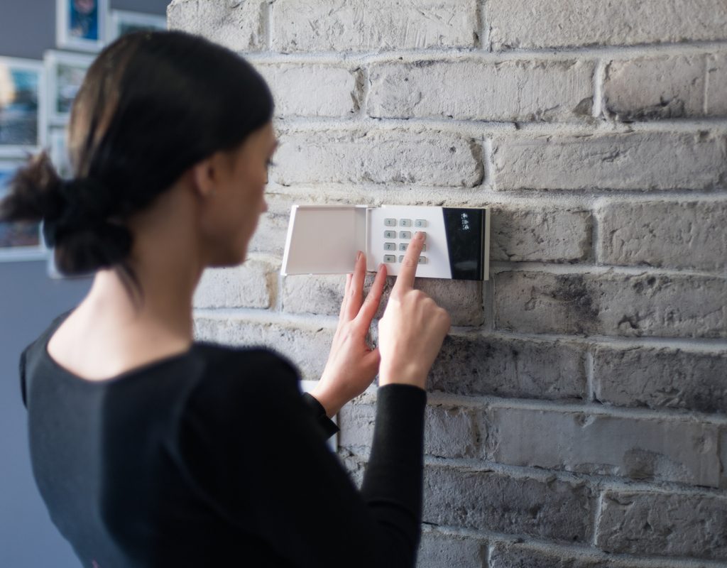 woman setting a security alarm