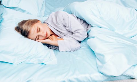Young Woman Sleeping On Silk Sheets