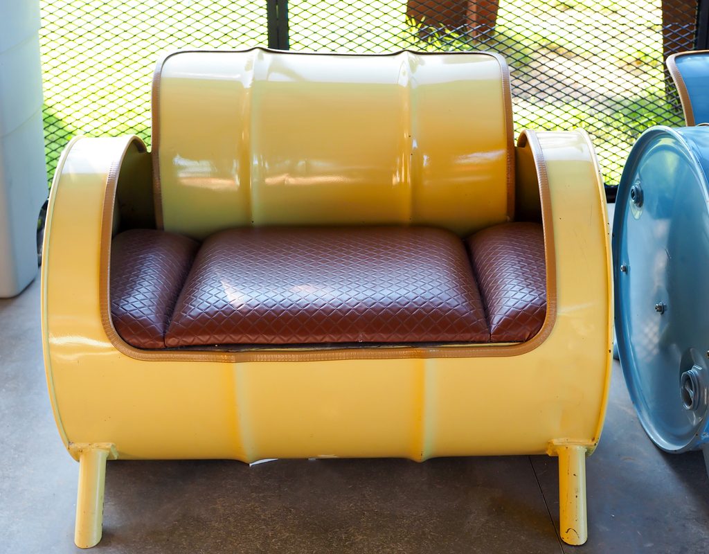 a chair made from a repurposed metal barrel