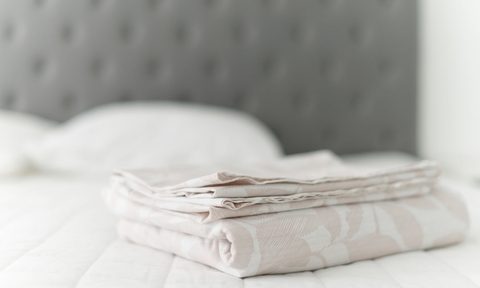 Clean sheets folded on bed
