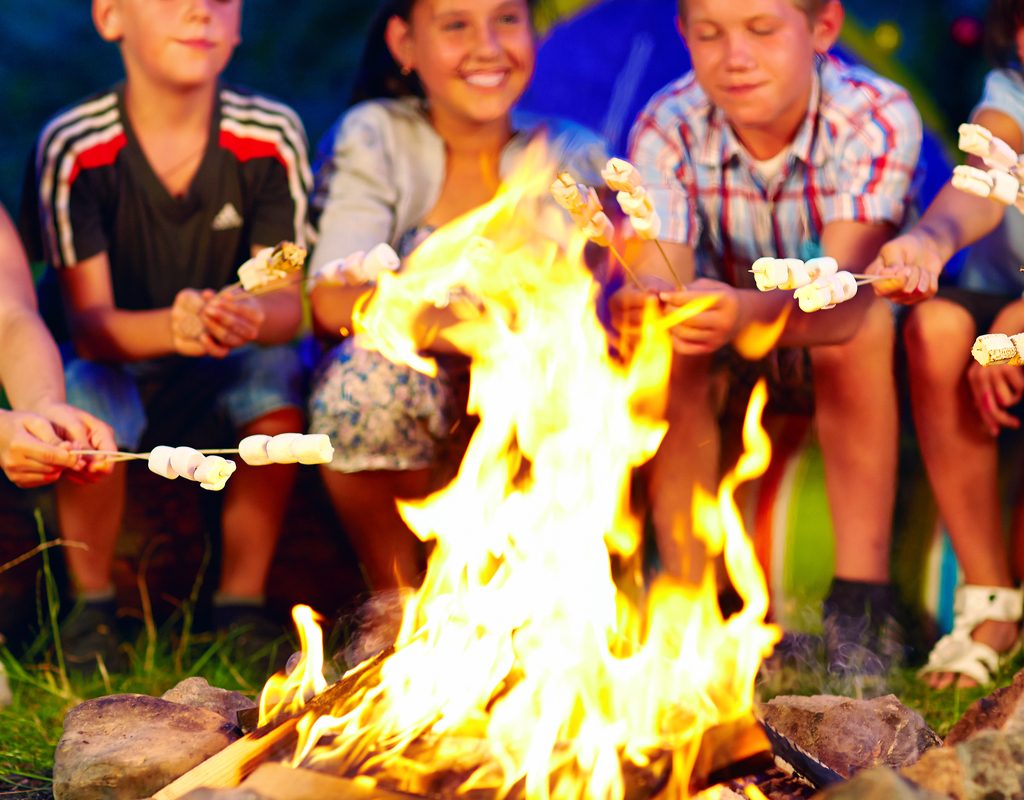 five kids toasting marshmallows