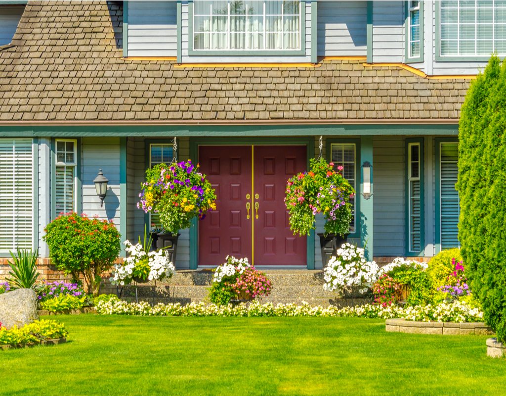front yard with nice landscaping blue house