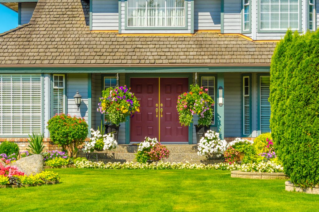front yard with nice landscaping blue house