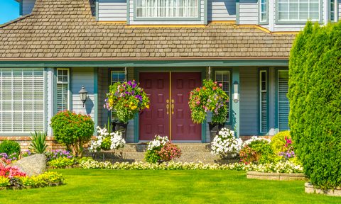 Front yard with nice landscaping at a blue house