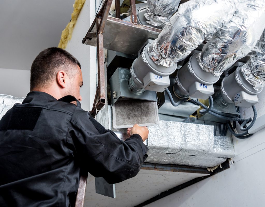repairman fixing hvac and ducts