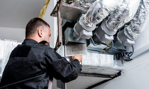 repairman fixing hvac and ducts
