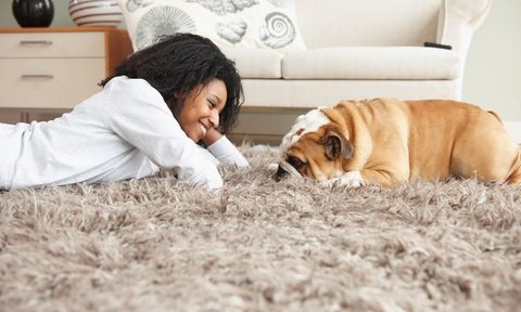 Woman on a rug with her dog