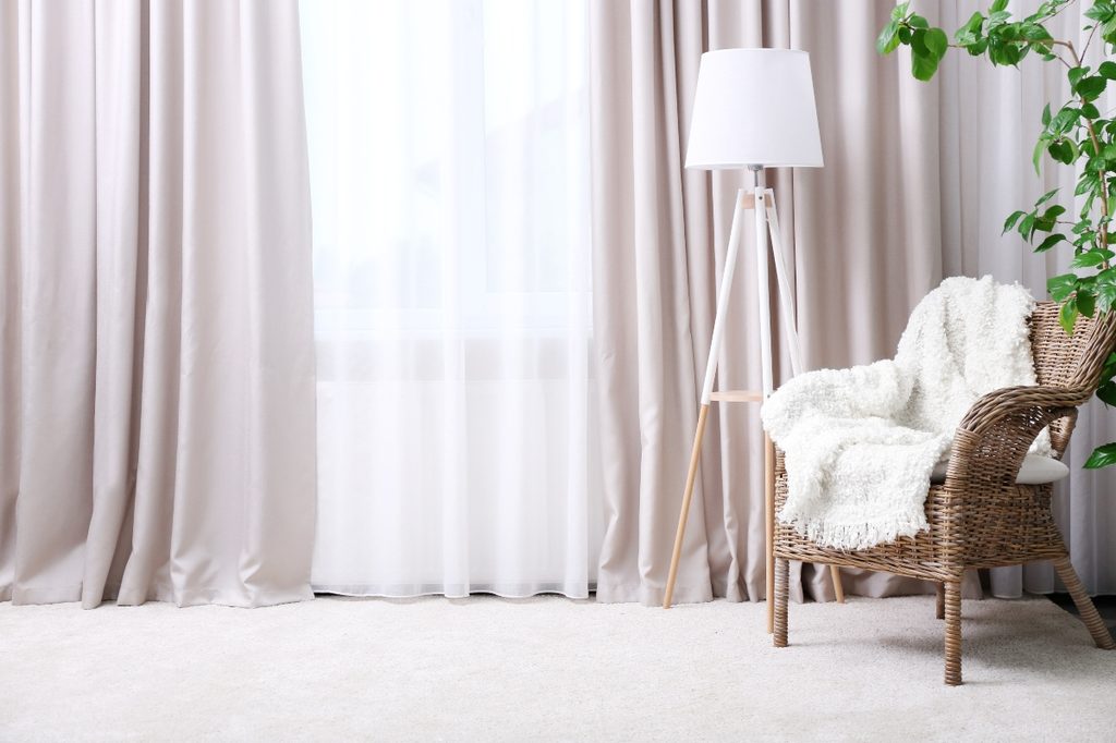 Sheer and gray curtains in a living room