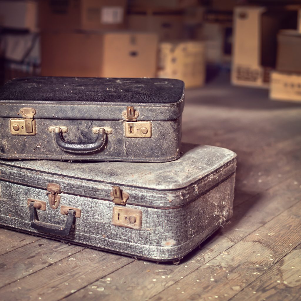 antique suitcases and boxes on wood attic floor
