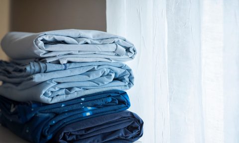 stack of blue folded sheets
