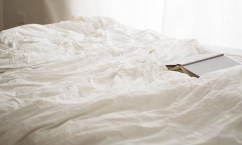 linen vs cotton sheets white and book on bed 1024x1024