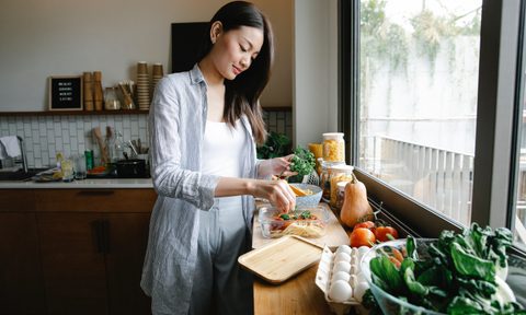 Asian woman sorting vegetables