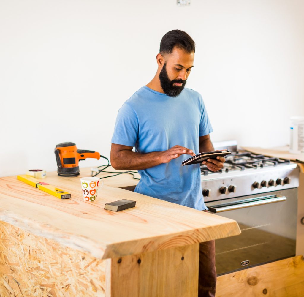 Kitchen renovations with man on a tablet