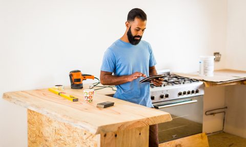 Kitchen renovations with man on a tablet