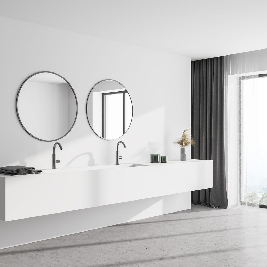 Modern floating vanity with round mirrors