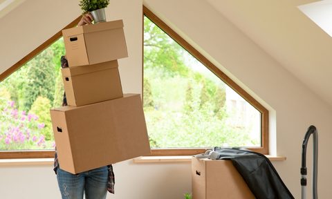 Person organizing boxes in their finished attic