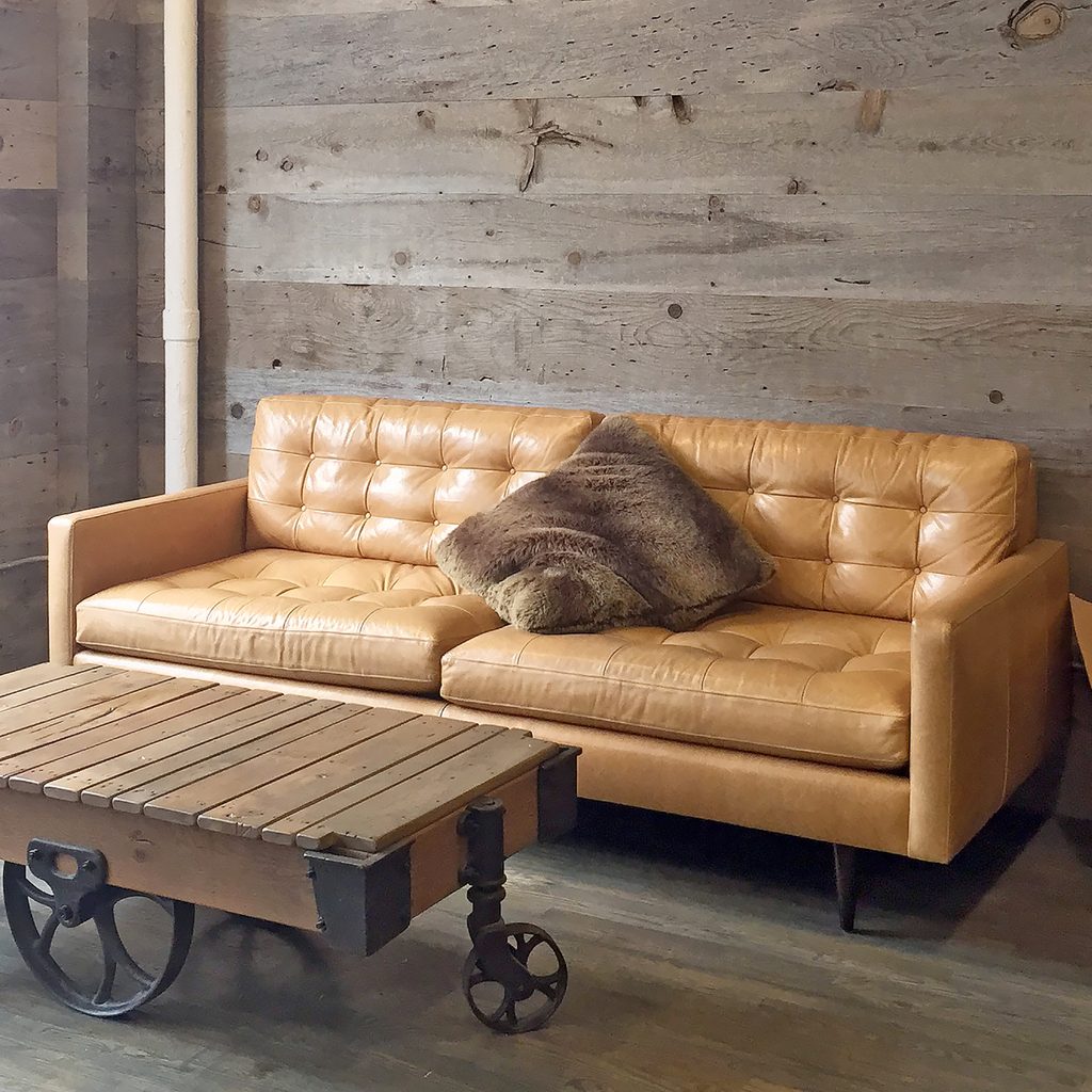 Rustic coffee table in living room with leather couch