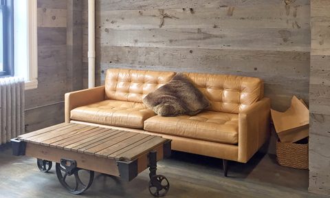 Rustic coffee table in living room with leather couch