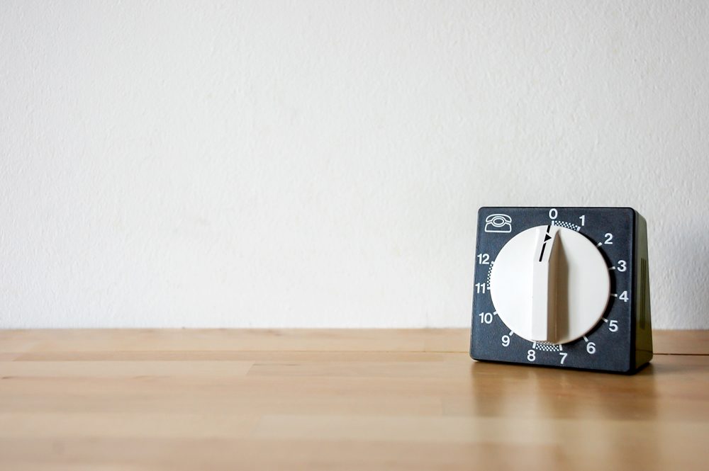 black and white kitchen timer on wood surface
