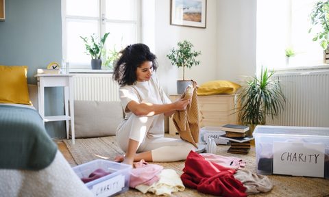 woman decluttering her bedroom