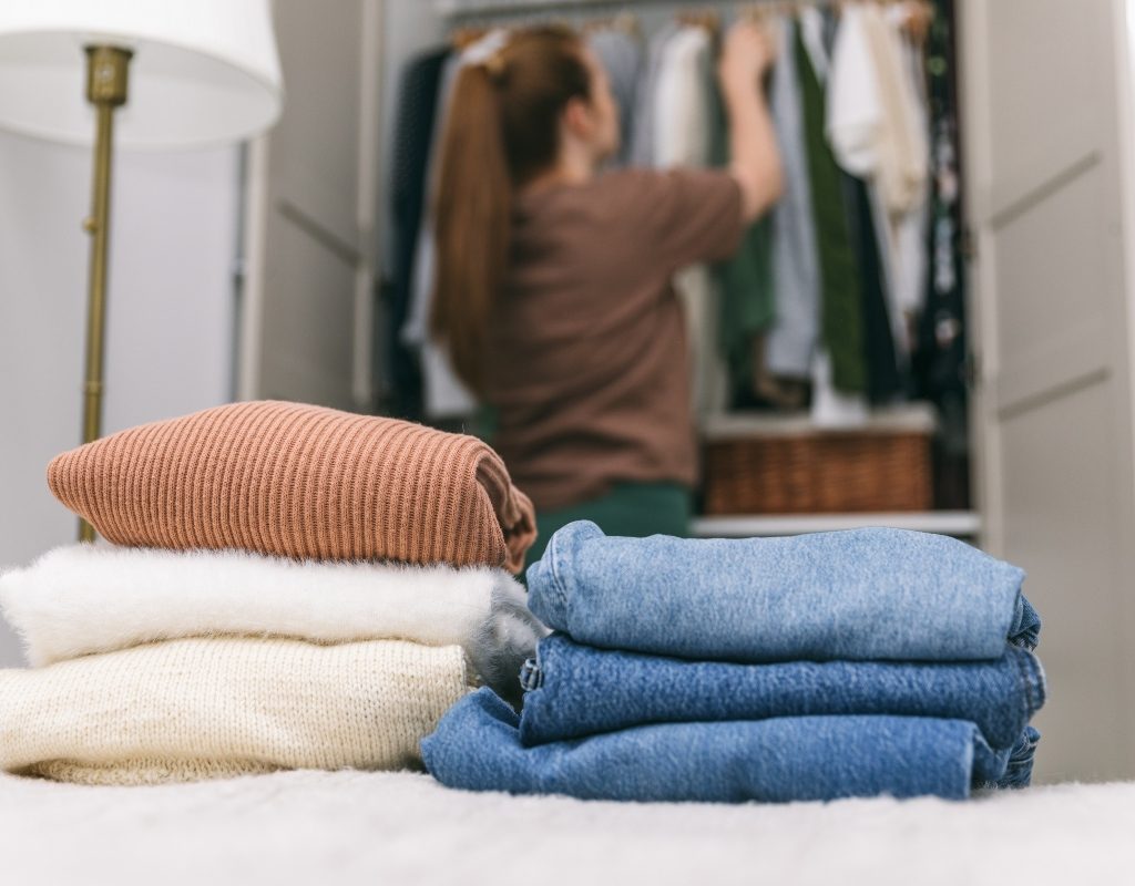 Woman decluttering the clothing in her closet