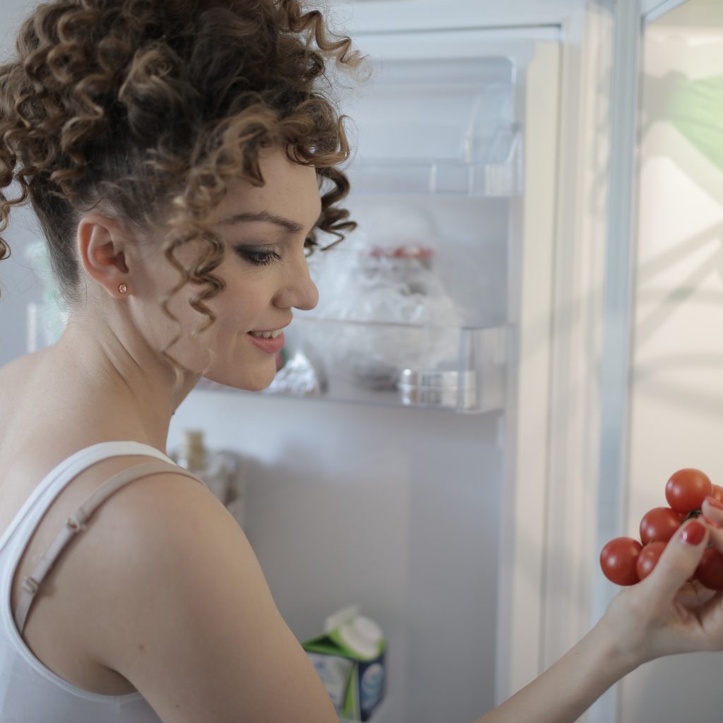 Woman looking at cherry tomatoes