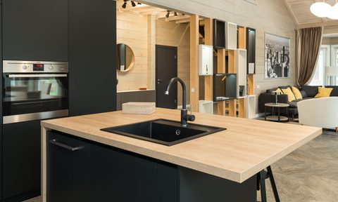 kitchen with dark cabinets and wooden countertop