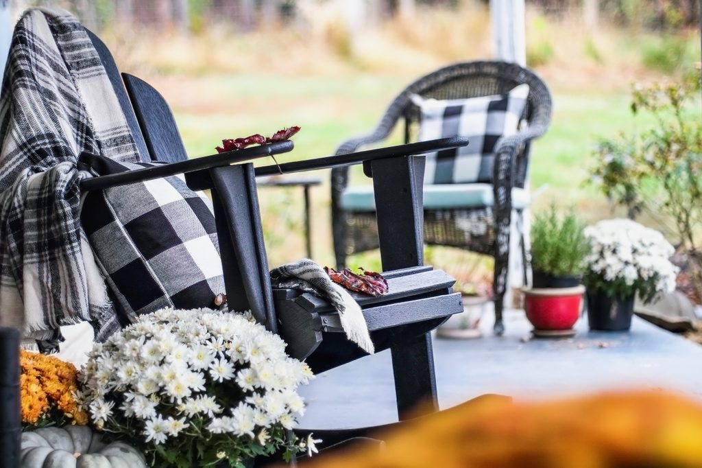 fall outdoor furniture with plaid blankets and pillows