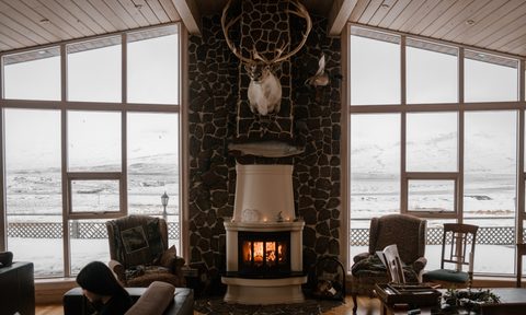 Grand brick fireplace with high shiplap ceiling
