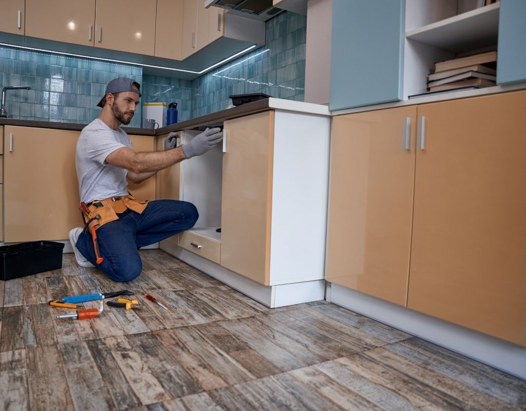 man remodeling kitchen cabinets