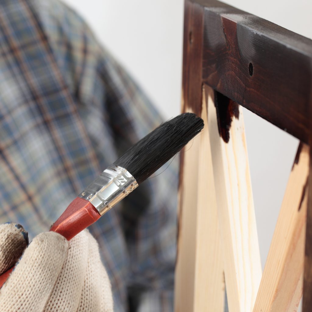 Man with glove and paintbrush