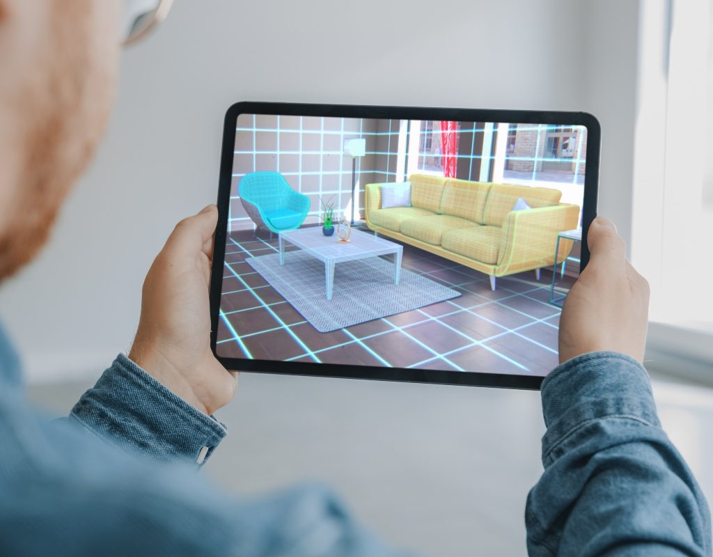 Person holding a tablet to perform an AR furniture placement