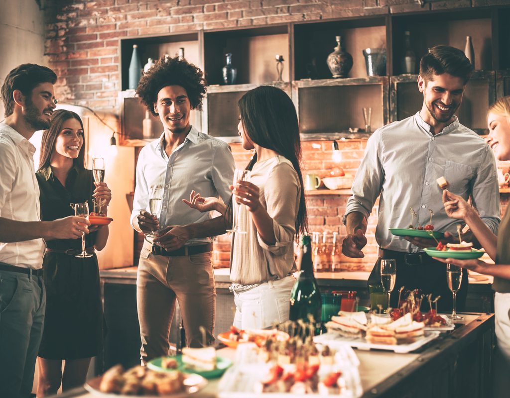 People at a party with snacks and drinks