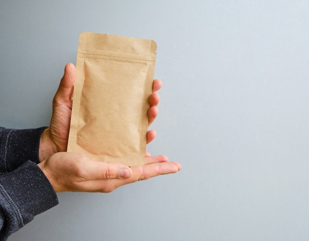 person holding eco friendly paper packaging