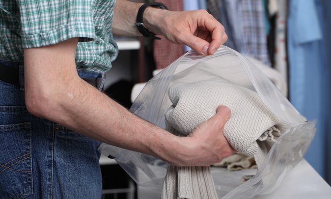 Man holding vacuum-sealed clothing