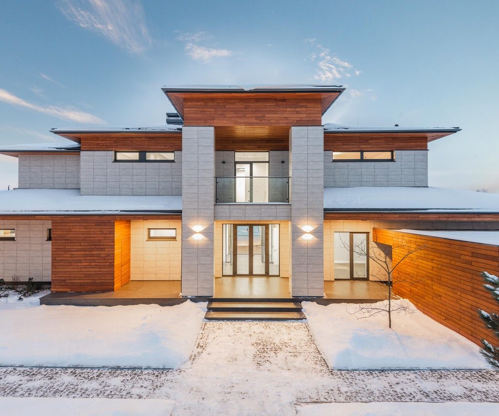 modern gray brick home in winter