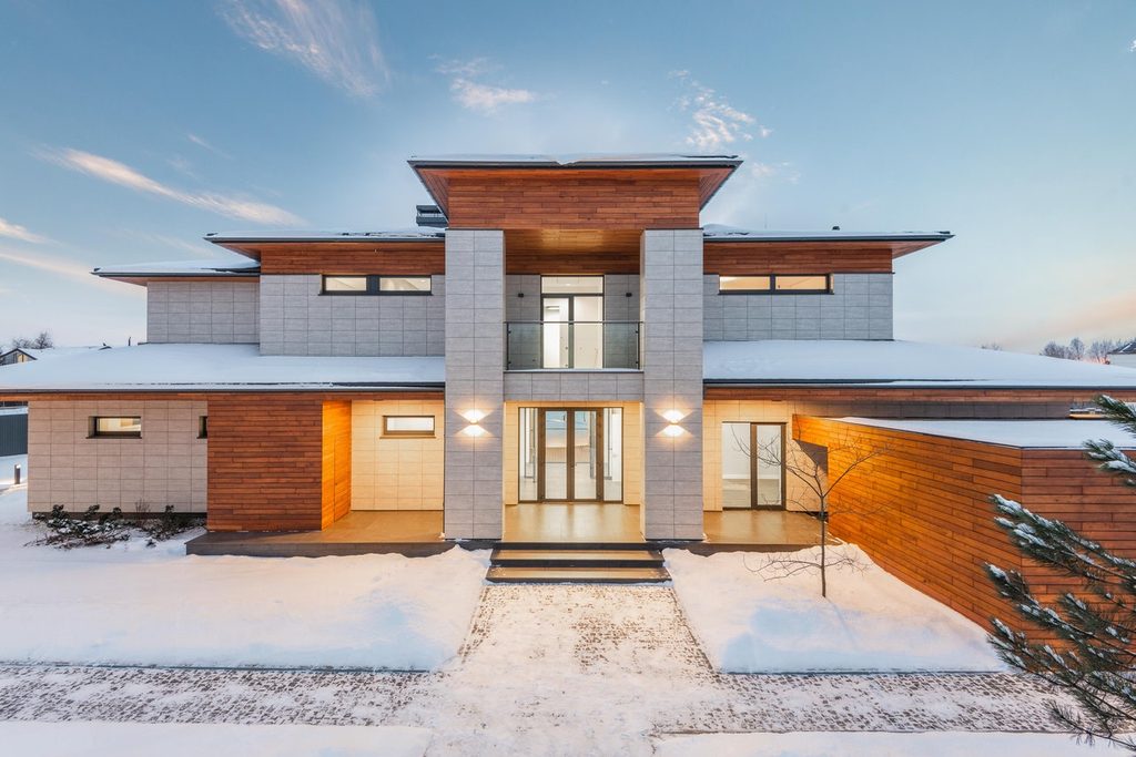 modern gray brick home in winter