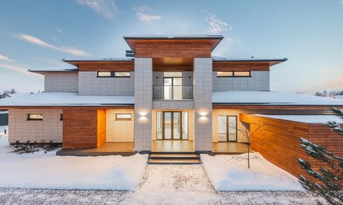 modern gray brick home in winter