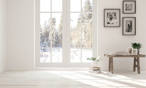 Winter outside through french doors in white living room