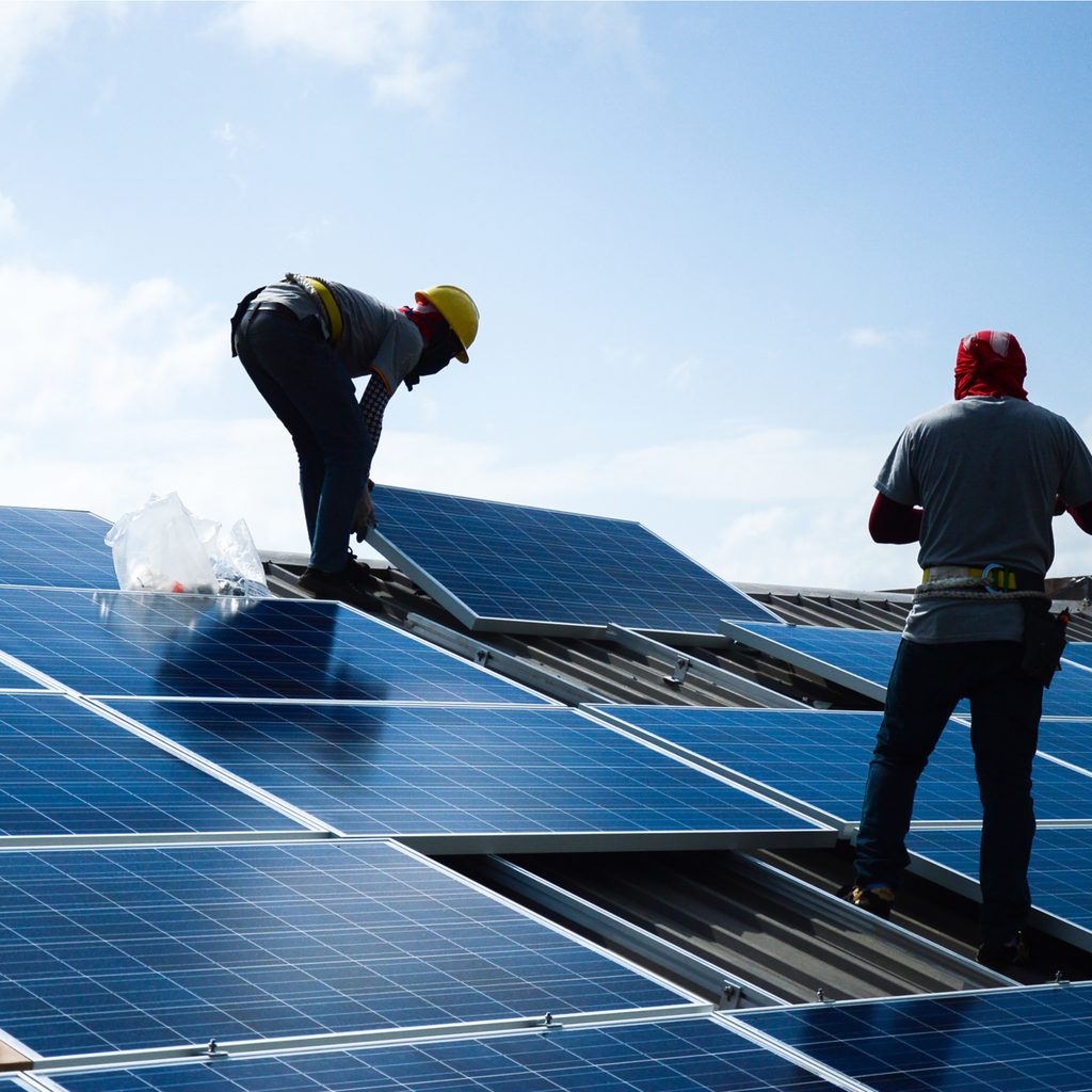 Workers installing solar panels