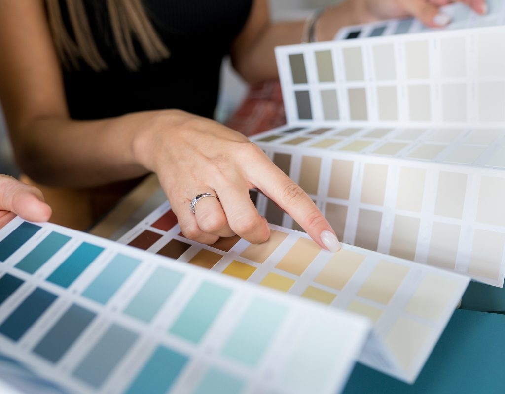 Person choosing paint colors from color pallet