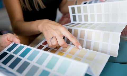 Person choosing paint colors from color pallet
