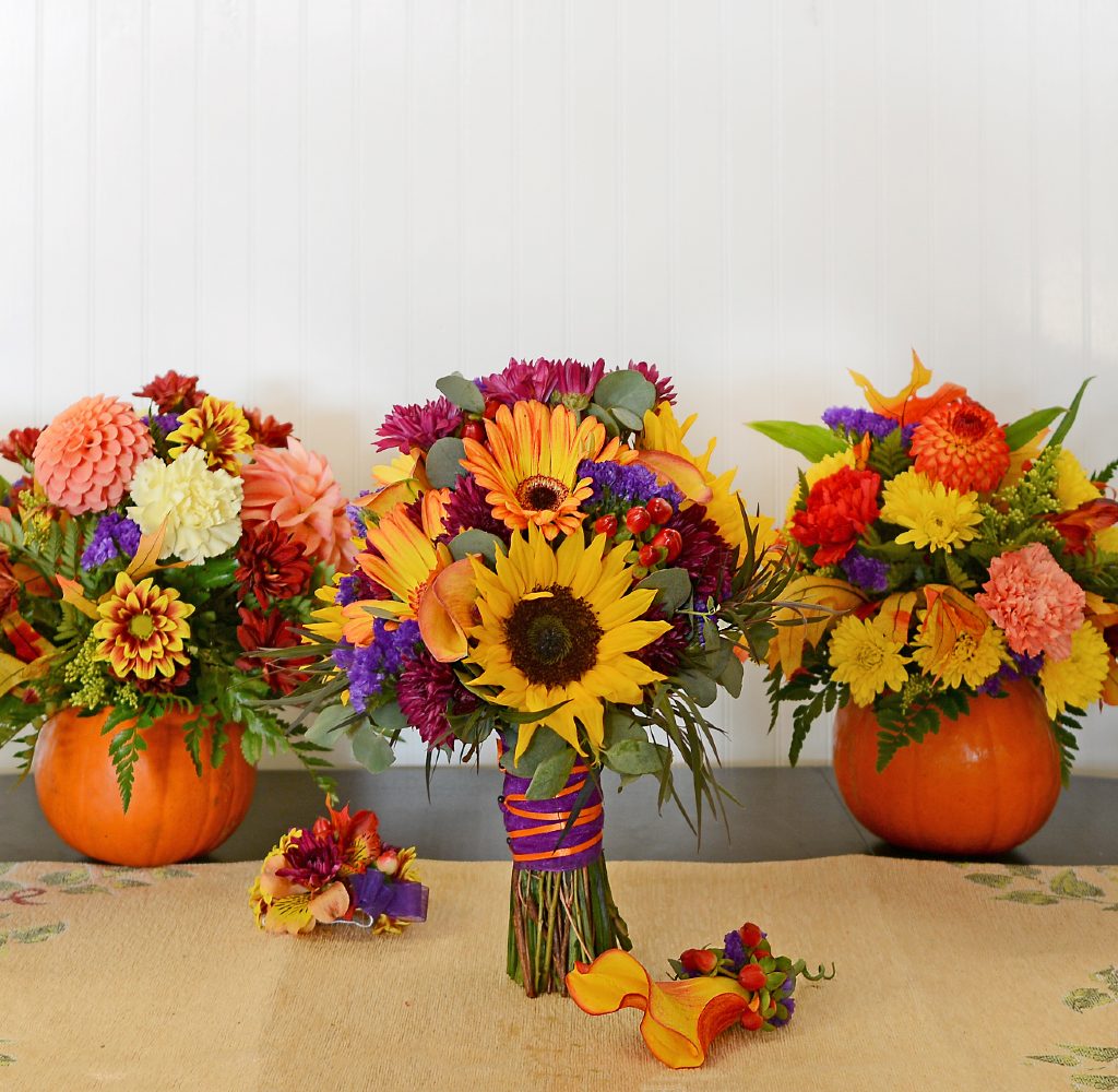 Pumpkins and fall flowers arranged for fall centerpieces