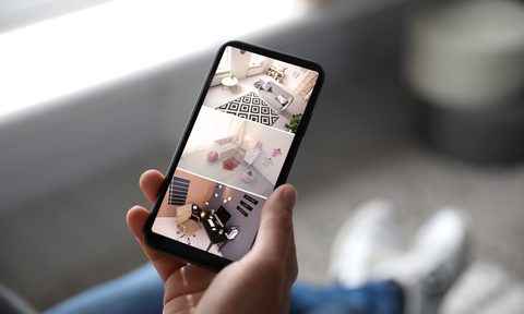 person holding phone and viewing home security footage