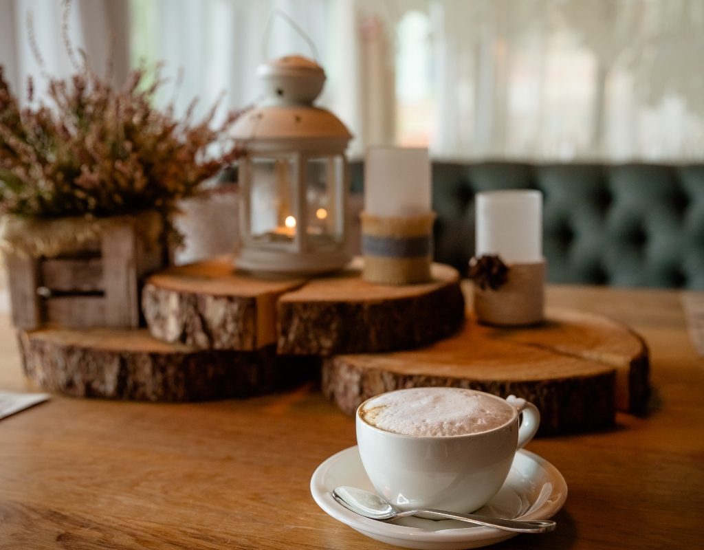 Raw wood with lantern and teacup on a rustic table