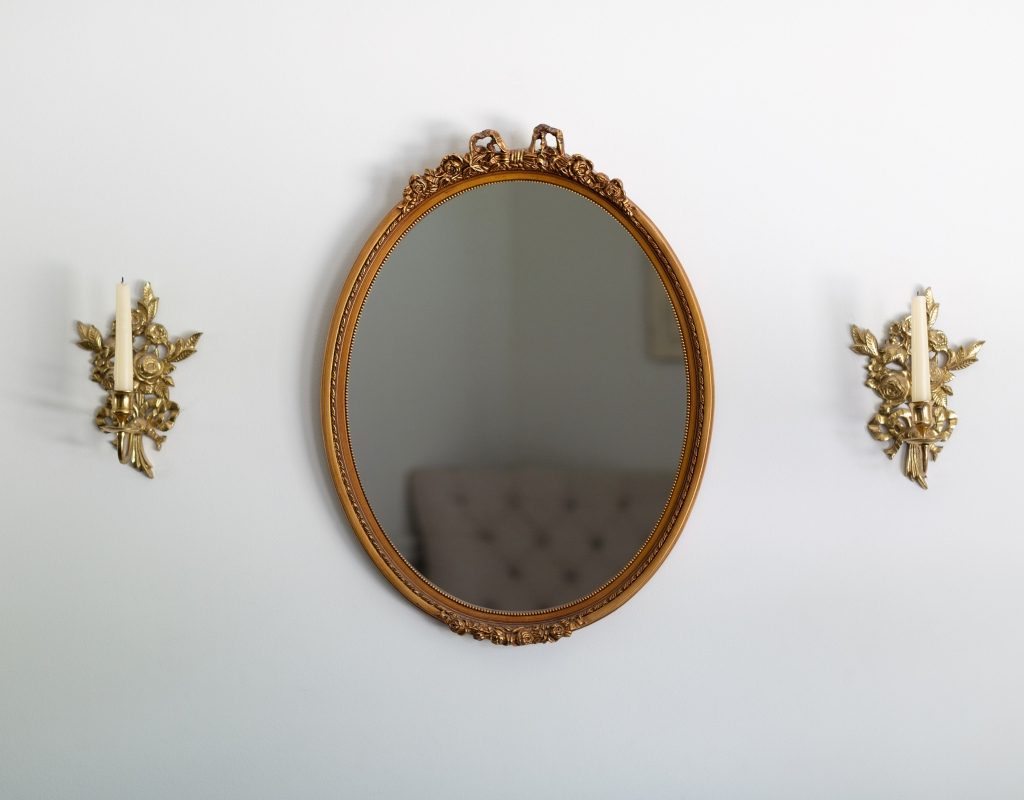 gold antique distressed mirror on white wall