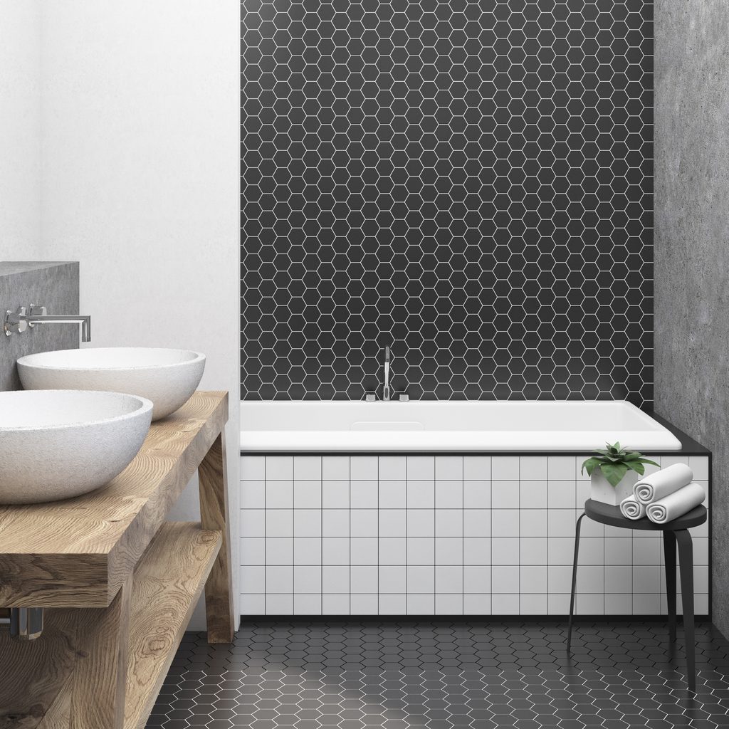 black and white bathroom with hexagon tile and concrete