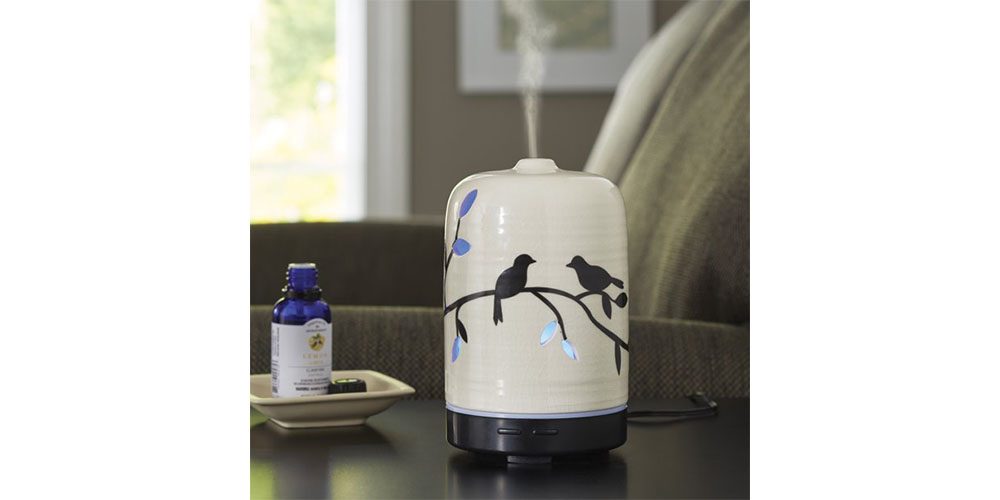 Better Homes & Gardens Essential Oil Diffuser placed on a countertop in a living room.